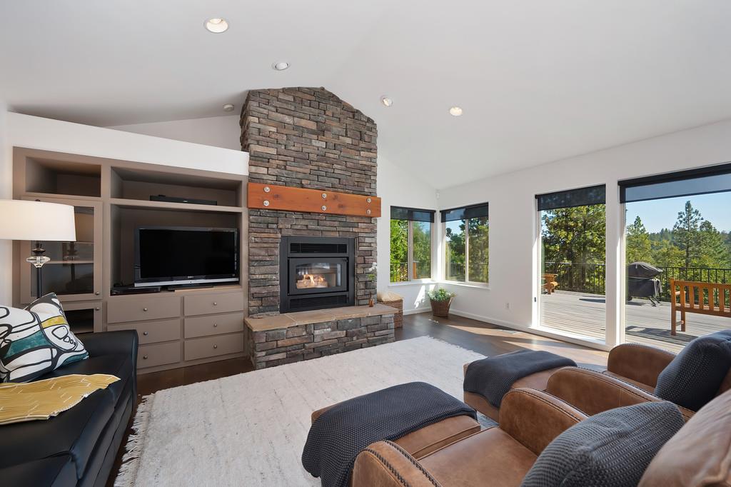 19676 Eagle Ridge Road Foresthill, CA 95631 - Photo 21 of 68 a living room with furniture a flat screen tv and a fireplace