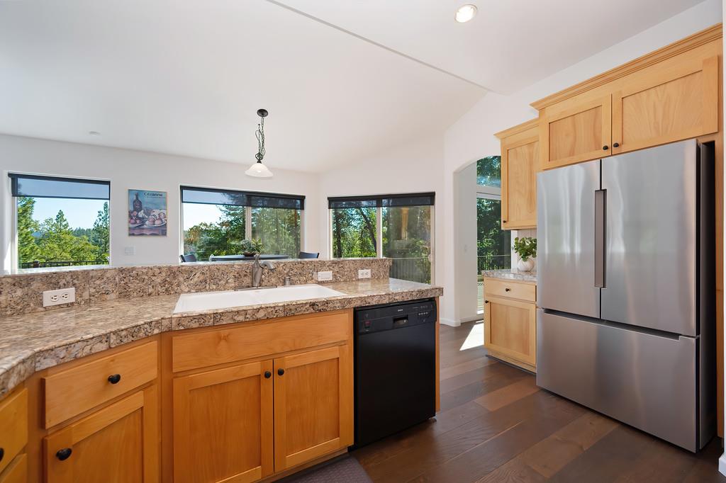 19676 Eagle Ridge Road Foresthill, CA 95631 - Photo 27 of 68 a kitchen with granite countertop stainless steel appliances a refrigerator a sink a stove and cabinets