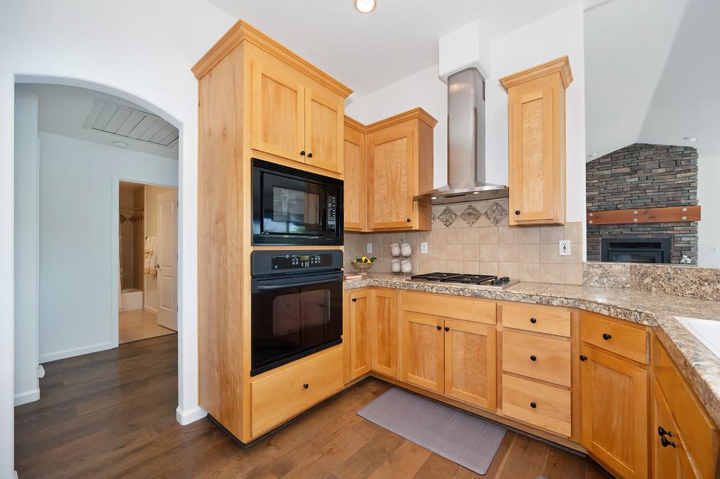 19676 Eagle Ridge Road Foresthill, CA 95631 - Photo 28 of 68 a kitchen with stainless steel appliances granite countertop a stove a sink and a microwave