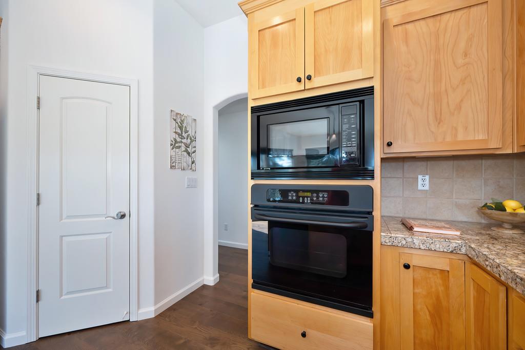 19676 Eagle Ridge Road Foresthill, CA 95631 - Photo 29 of 68 a kitchen with granite countertop cabinets stainless steel appliances and wooden floor