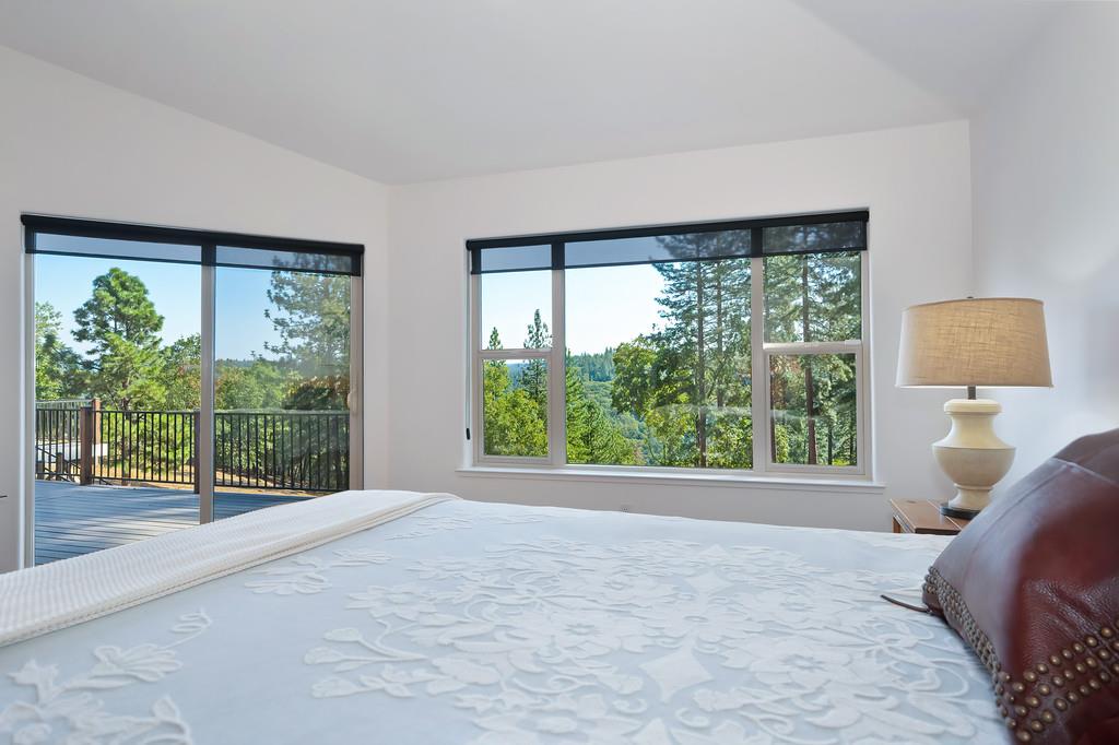 19676 Eagle Ridge Road Foresthill, CA 95631 - Photo 33 of 68 a view of a bedroom with a large window and a bed