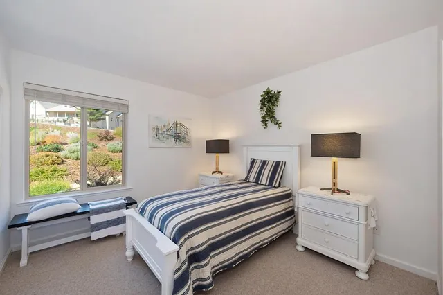 a view of a balcony with wooden floor and fence