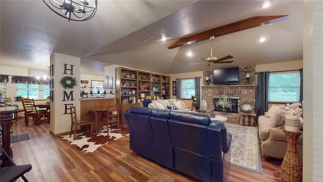 a living room with fireplace furniture and a wooden floor