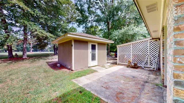 a view of backyard with a barn and large trees