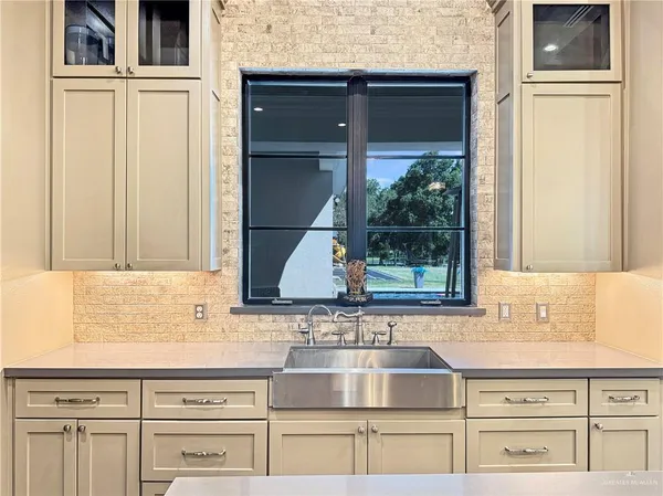 a kitchen with stainless steel appliances granite countertop a sink and a window