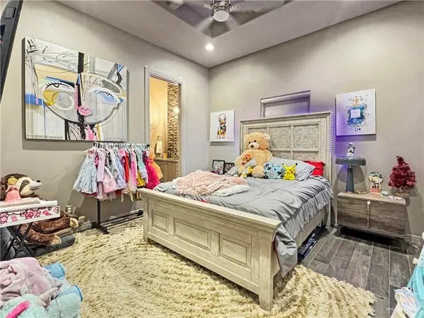 a bedroom with a bed and a chandelier