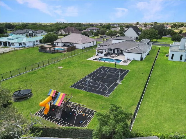 an aerial view of a house with garden space and street view