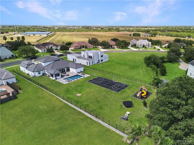 an aerial view of a city with lots of residential buildings and mountain view in back