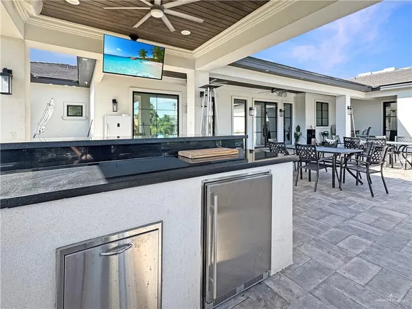 a kitchen with stainless steel appliances granite countertop a sink a stove and cabinets