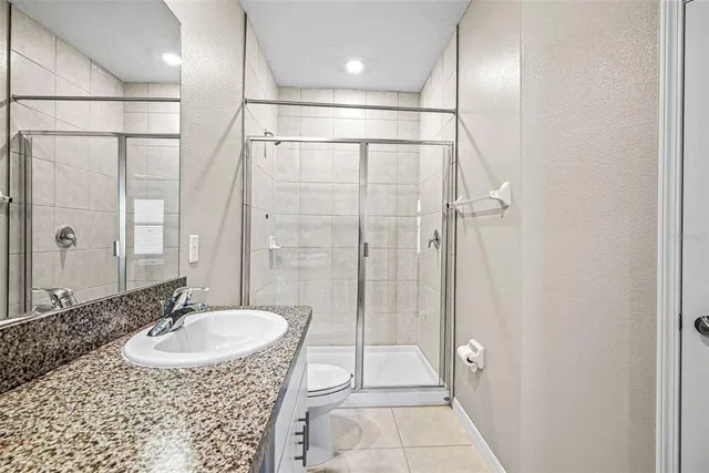 a bathroom with a sink shower and a mirror