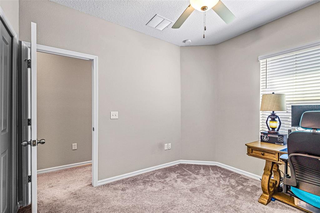 31945 Blue Passing Loop Wesley Chapel, FL 33545 - Photo 16 of 22 a view of workspace with livingroom