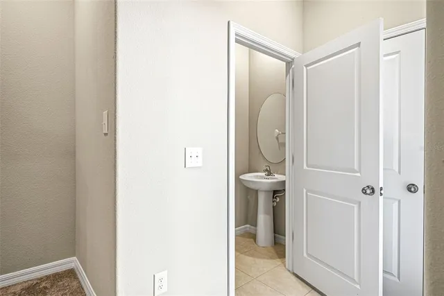 a bathroom with a glass shower door and mirror