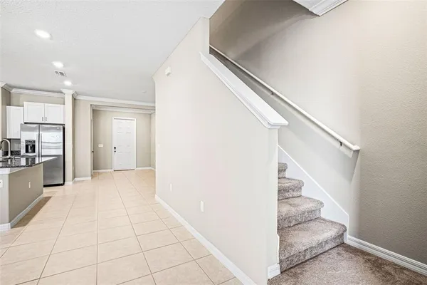 a view of entryway and hall with a living room