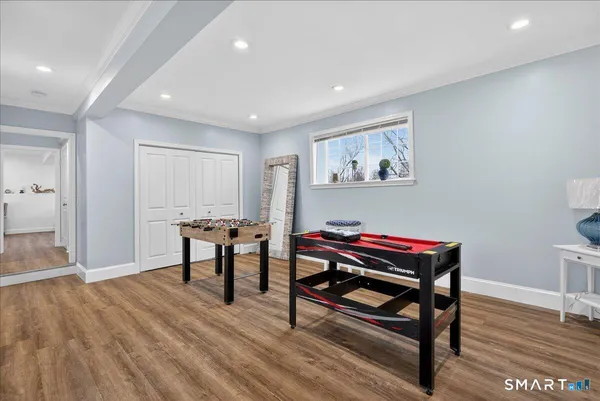 a view of a room with furniture and wooden floor