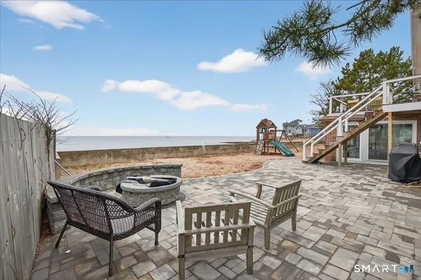 a bedroom with a bed and a chair with the bookshelf