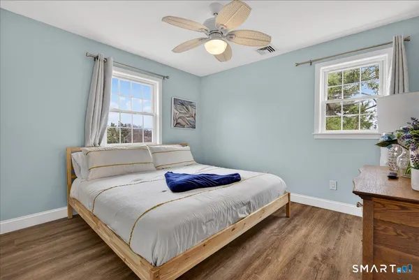 a bedroom with a bed and flat screen tv
