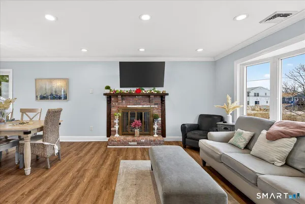a living room with fireplace furniture and a flat screen tv