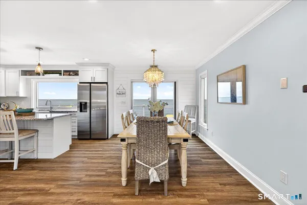a view of a dining room with furniture window and wooden floor