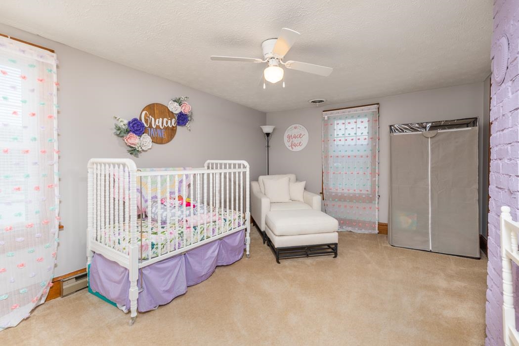 588 Concord Church Road Timberville, VA 22853 - Photo 12 of 32 a bedroom with a bed and a chandelier