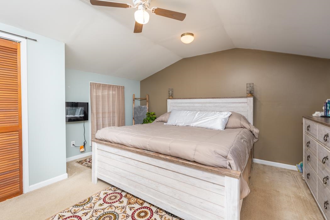 588 Concord Church Road Timberville, VA 22853 - Photo 17 of 32 a bedroom with a bed and a chandelier