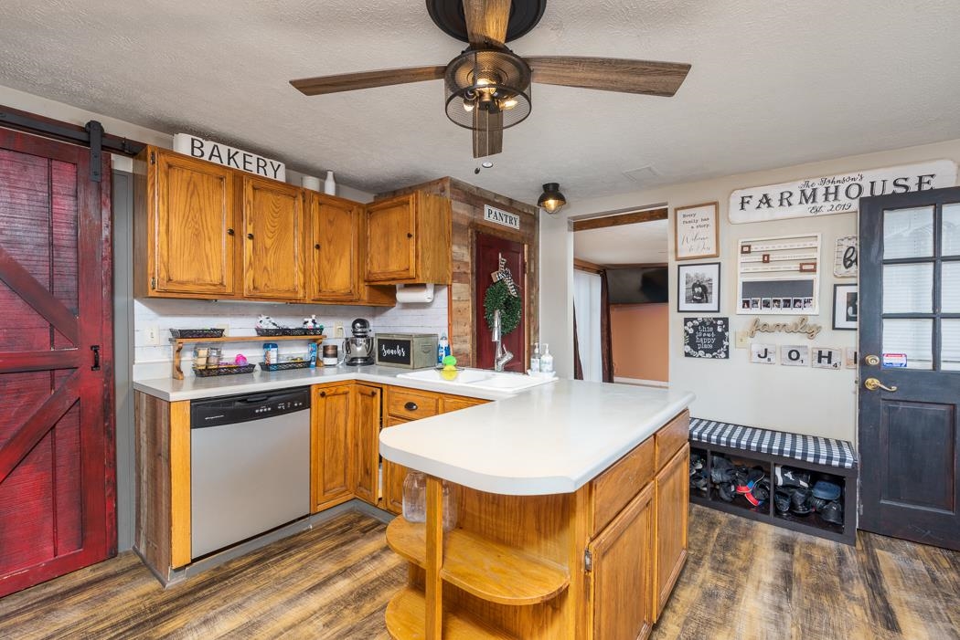 588 Concord Church Road Timberville, VA 22853 - Photo 3 of 32 a kitchen with stainless steel appliances granite countertop a sink dishwasher and a refrigerator with wooden floor