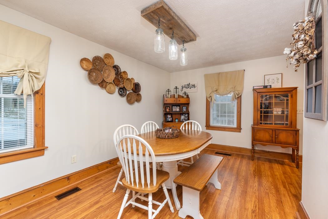 588 Concord Church Road Timberville, VA 22853 - Photo 8 of 32 a dining room with furniture a chandelier and wooden floor