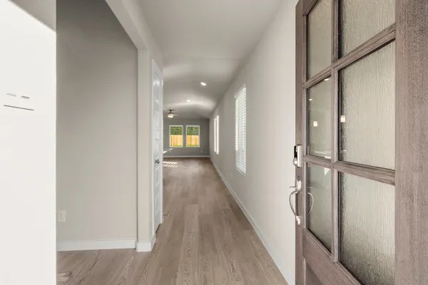 a view of a hallway with wooden floor