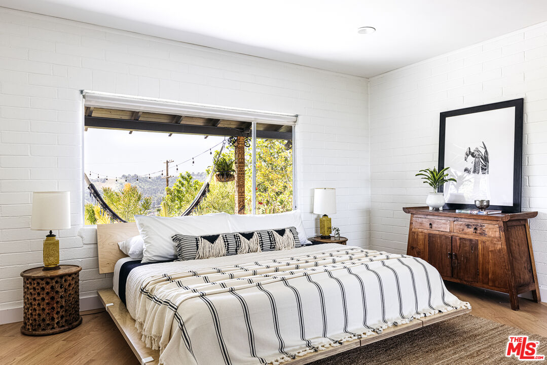 811 Montecito Drive Los Angeles, CA 90031 - Photo 11 of 25 a bedroom with a large bed and a table