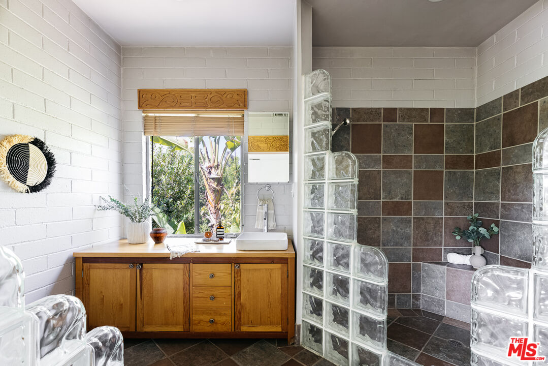 811 Montecito Drive Los Angeles, CA 90031 - Photo 13 of 25 a bathroom with a double vanity sink a mirror and a shower