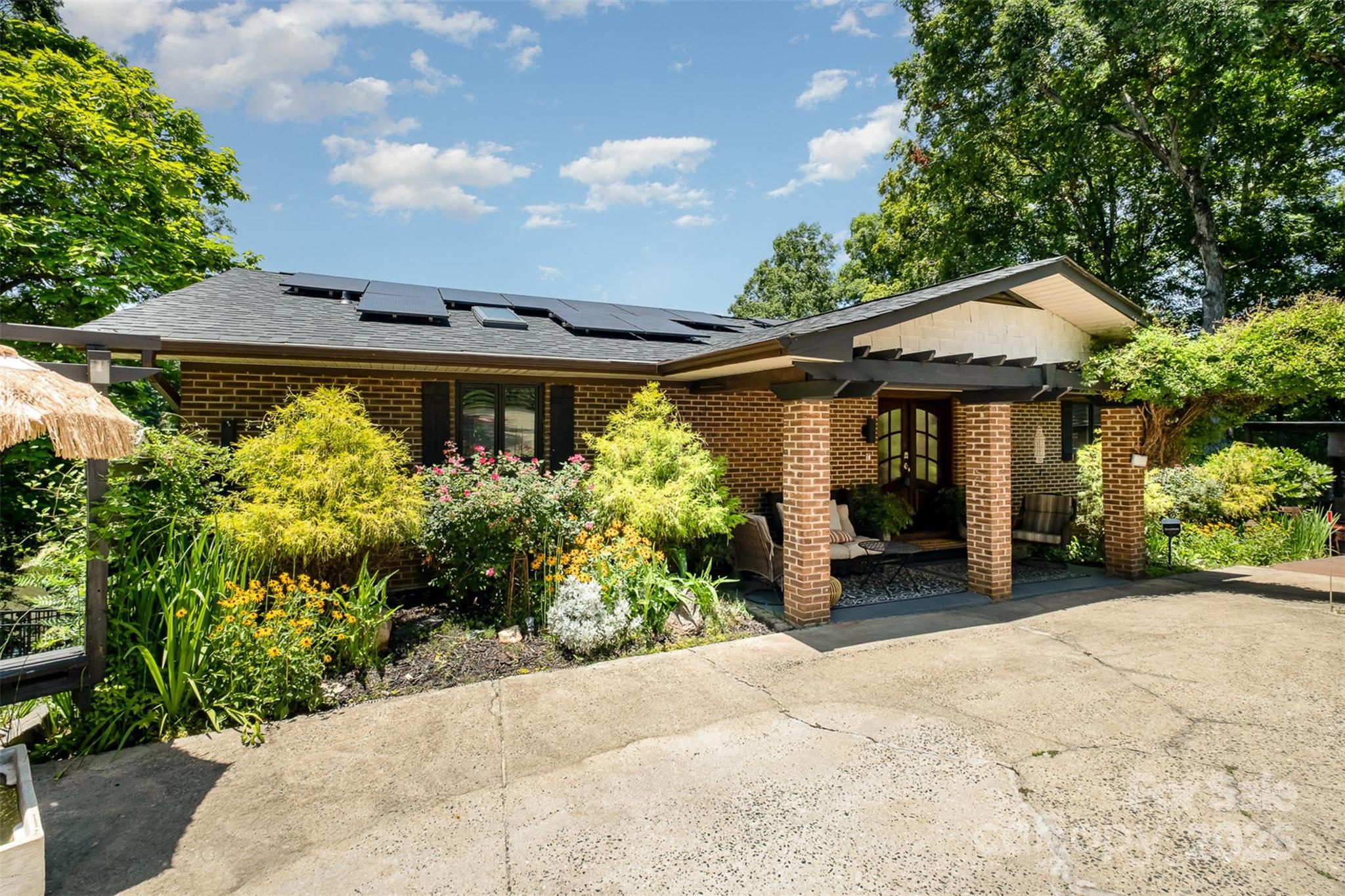a front view of a house with a garden