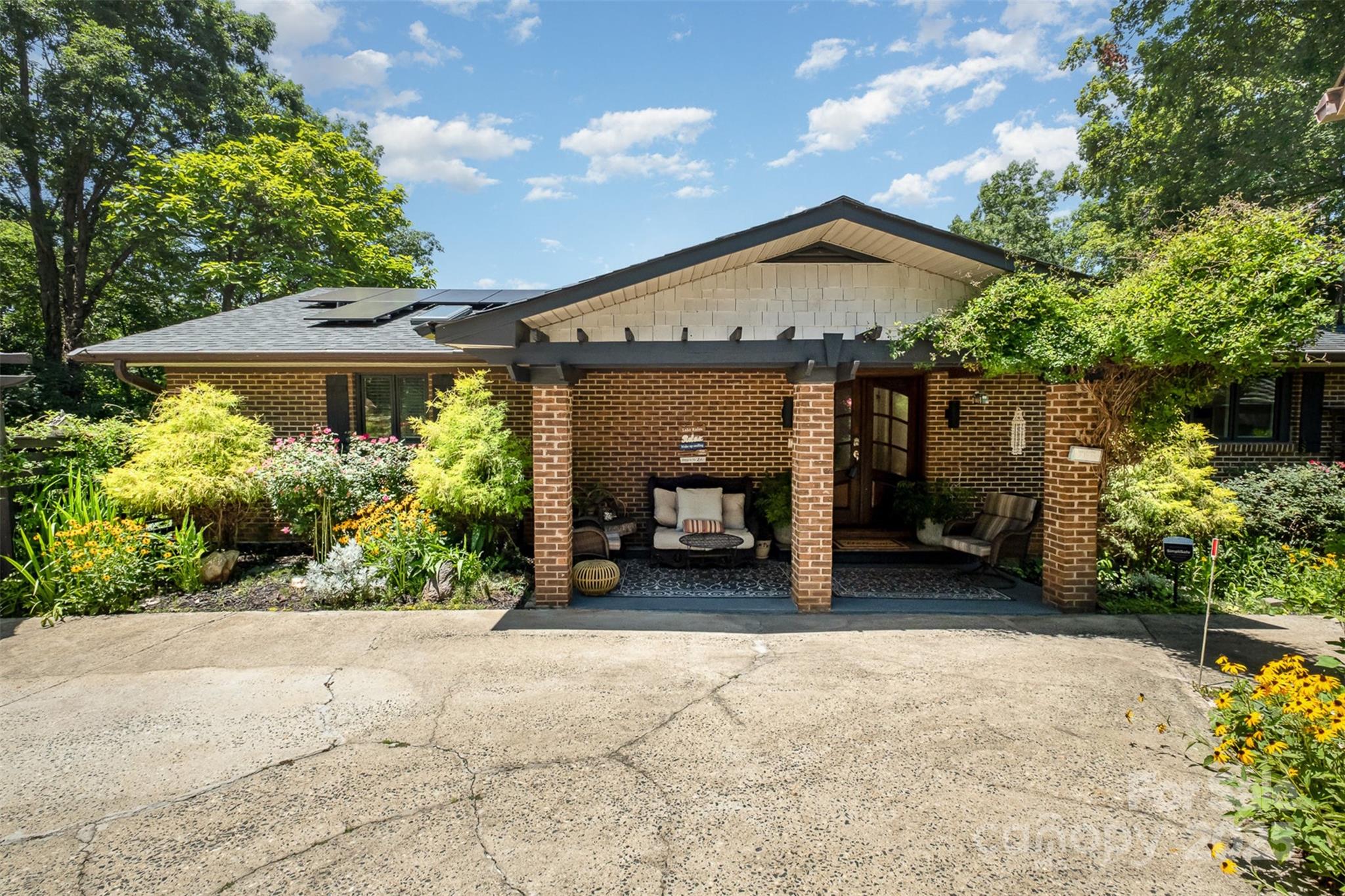 9500 Windygap Road Charlotte, NC 28278 - Photo 3 of 48 a front view of a house with a yard and garage
