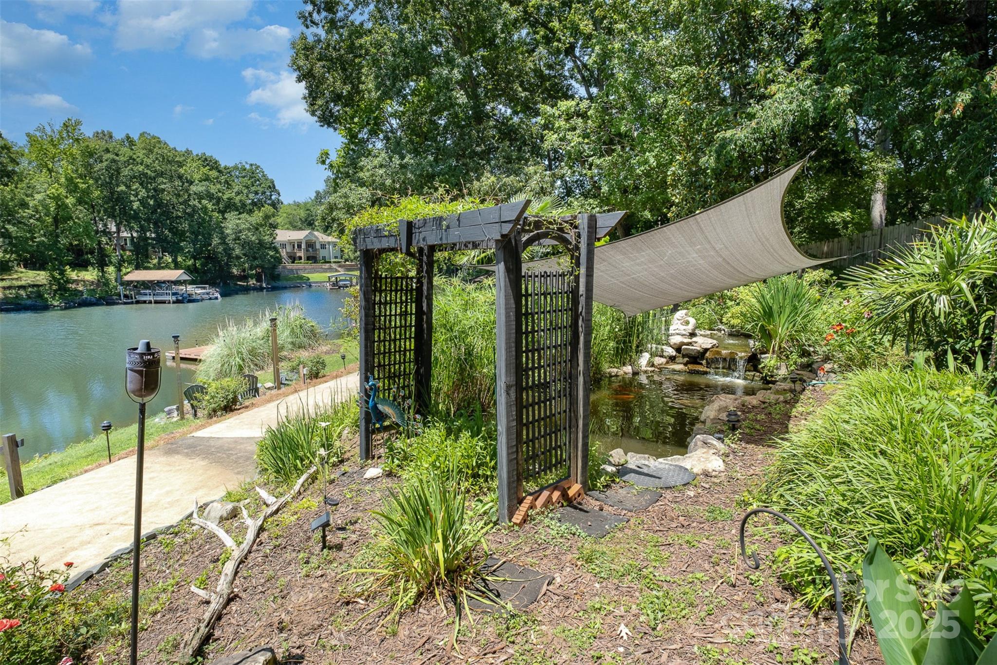 9500 Windygap Road Charlotte, NC 28278 - Photo 37 of 48 a view of a lake with a floor to ceiling window and wooden fence