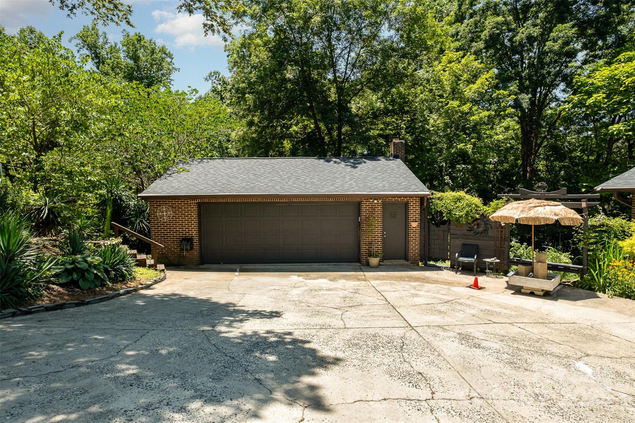 9500 Windygap Road Charlotte, NC 28278 - Photo 39 of 48 a backyard of a house with table and chairs under an umbrella