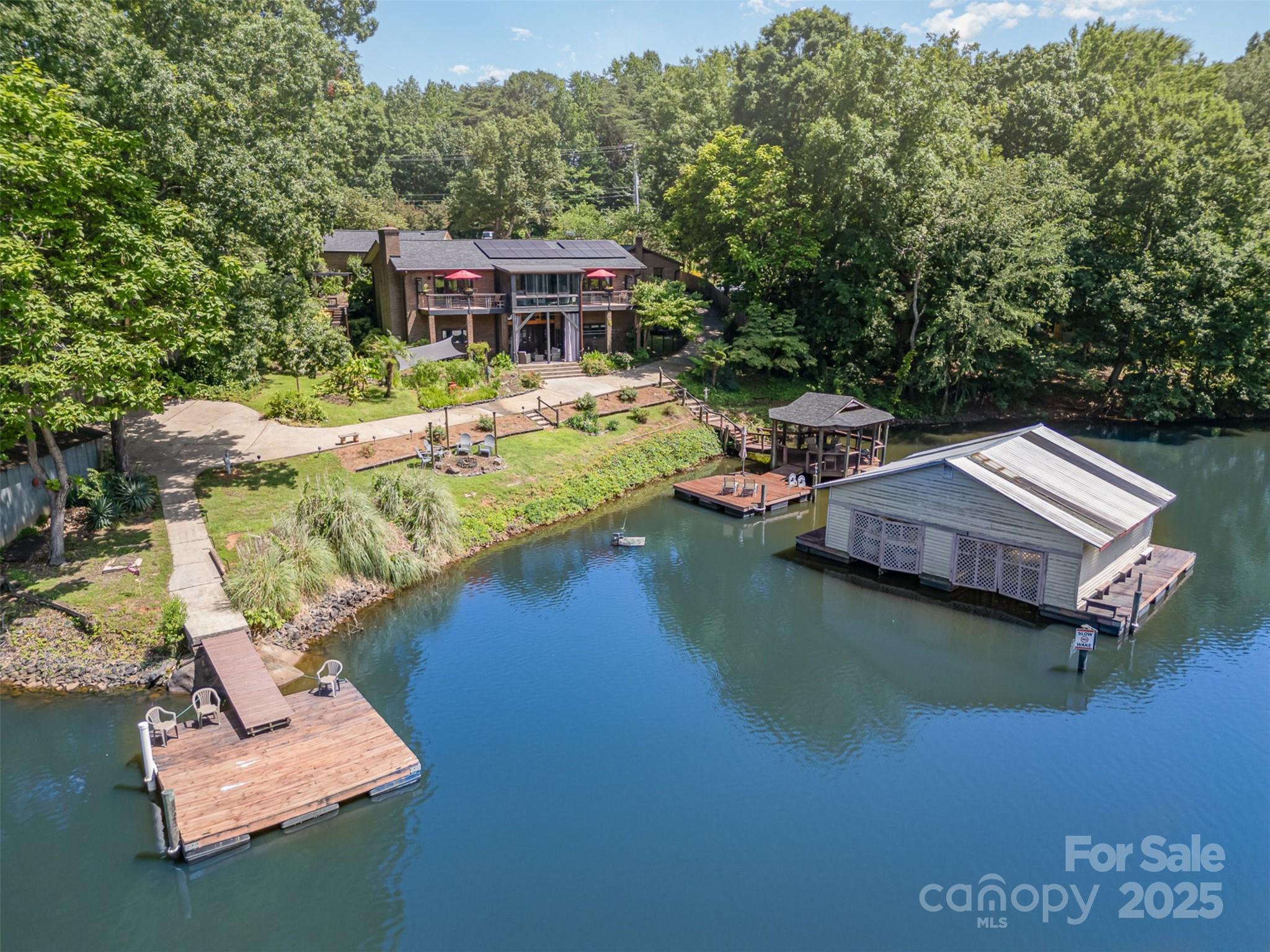 9500 Windygap Road Charlotte, NC 28278 - Photo 46 of 48 an aerial view of a house with swimming pool and lake view