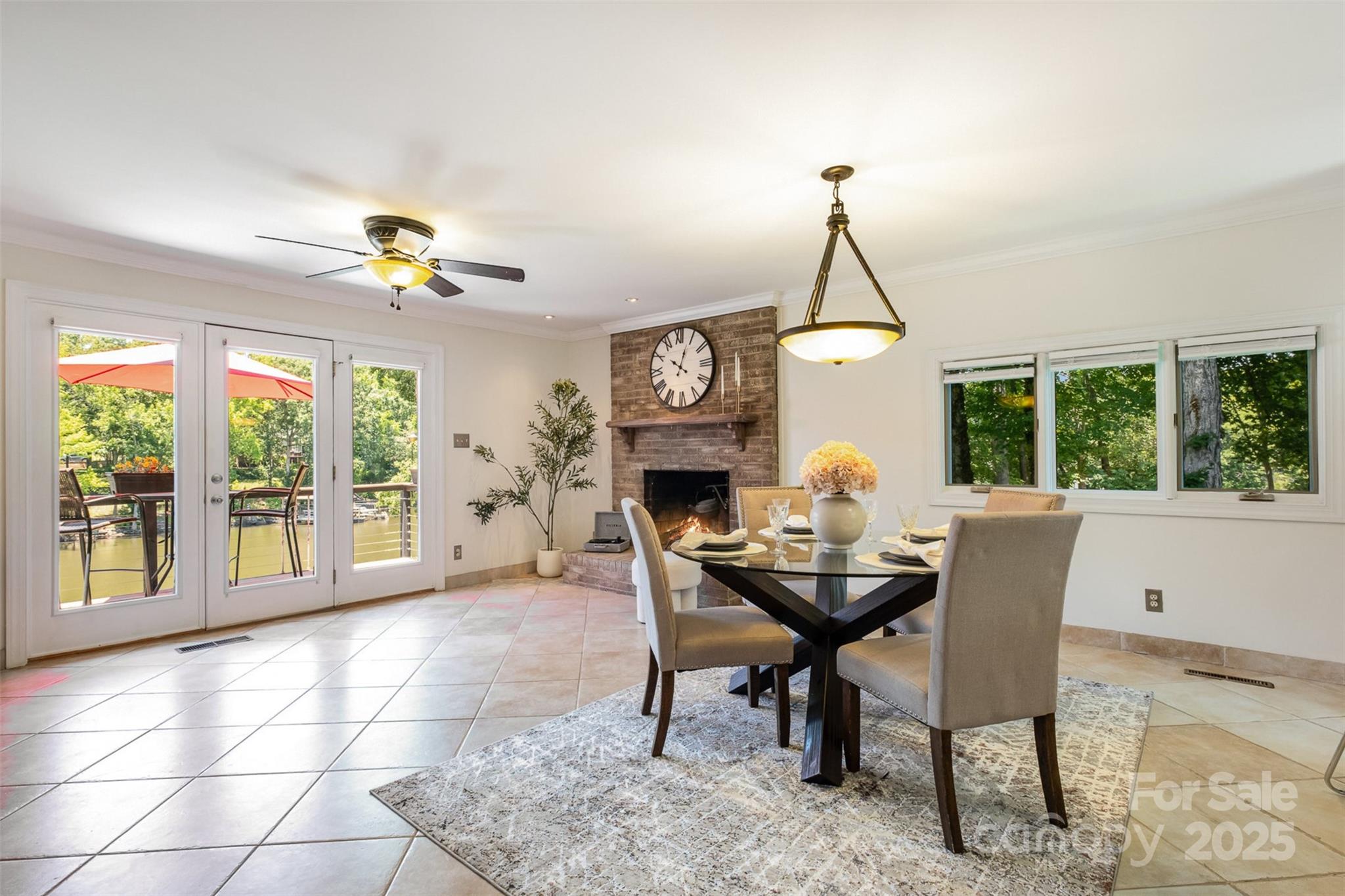 9500 Windygap Road Charlotte, NC 28278 - Photo 9 of 48 a dining room with furniture a chandelier and a rug