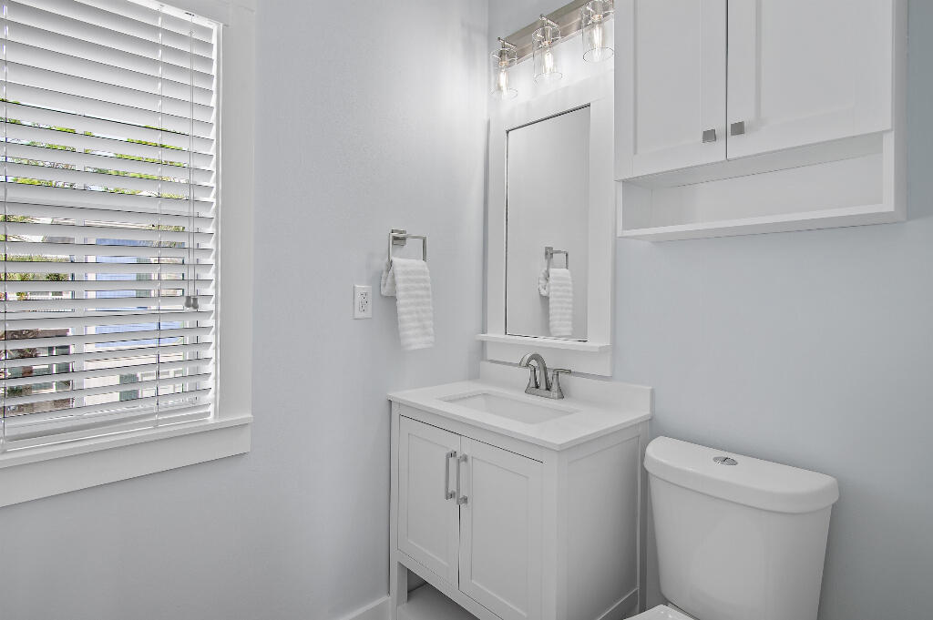 198 Somerset Bridge Road, Unit 123 Santa Rosa Beach, FL 32459 - Photo 14 of 21 a bathroom with a sink a toilet and a window