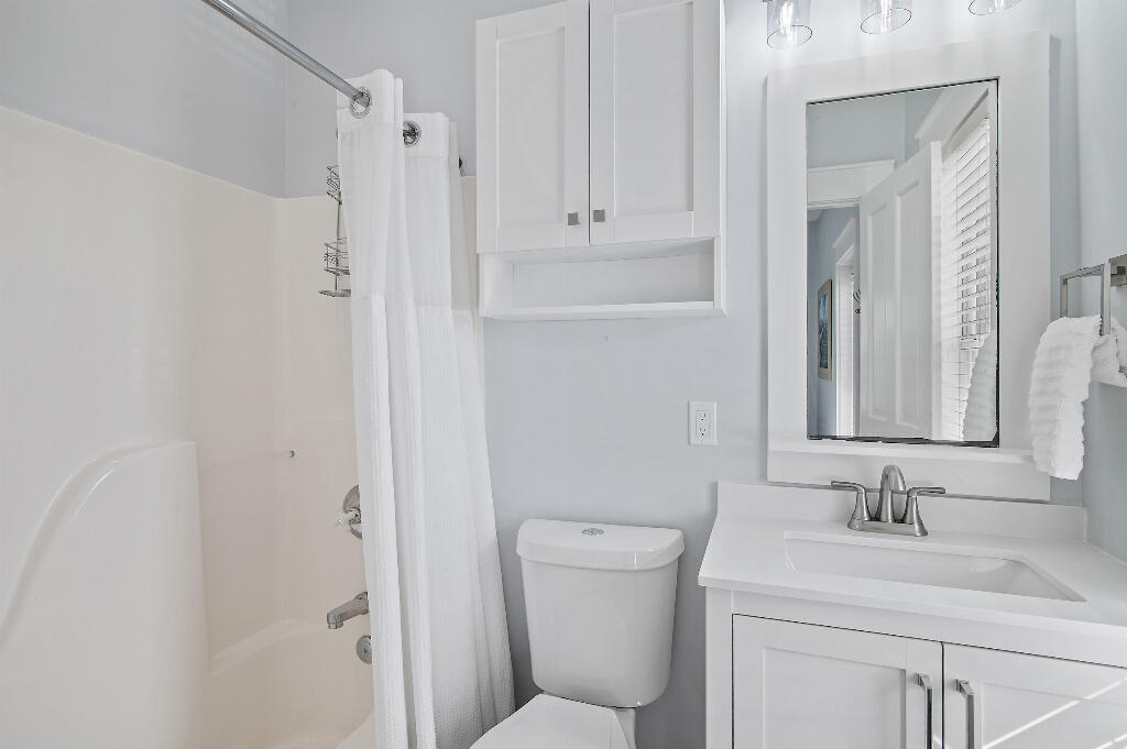 198 Somerset Bridge Road, Unit 123 Santa Rosa Beach, FL 32459 - Photo 16 of 21 a bathroom with a granite countertop sink toilet and shower