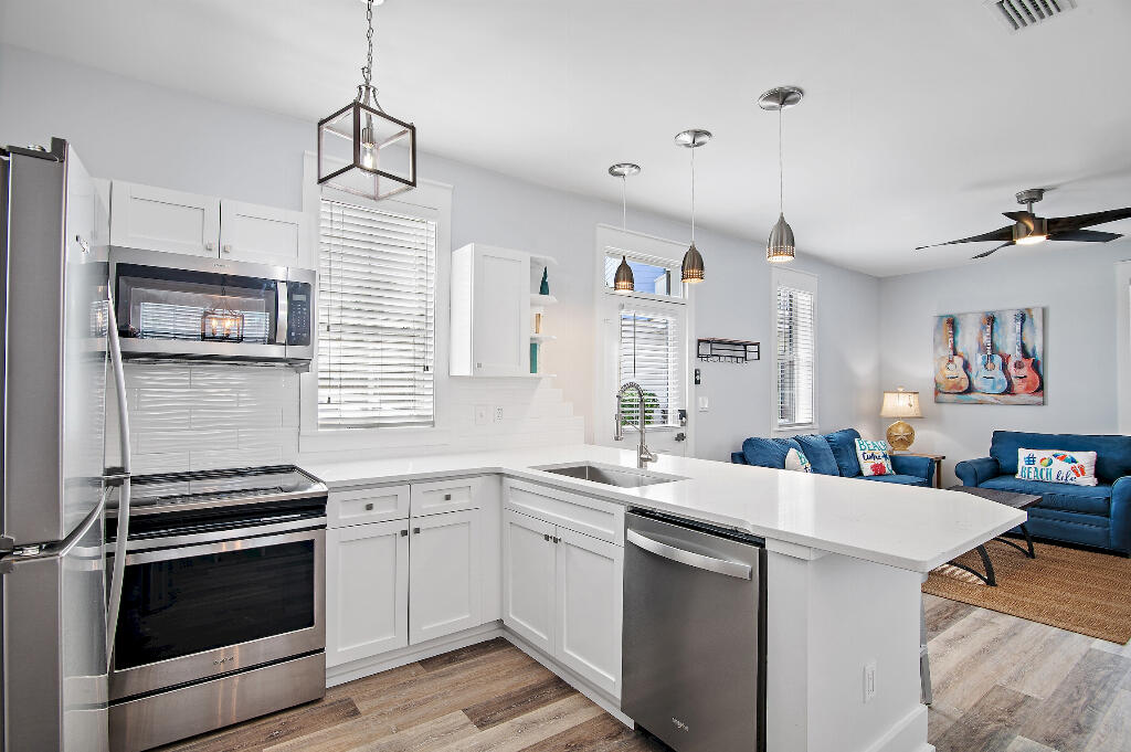 198 Somerset Bridge Road, Unit 123 Santa Rosa Beach, FL 32459 - Photo 6 of 21 a kitchen with a sink stainless steel appliances a sink and a refrigerator