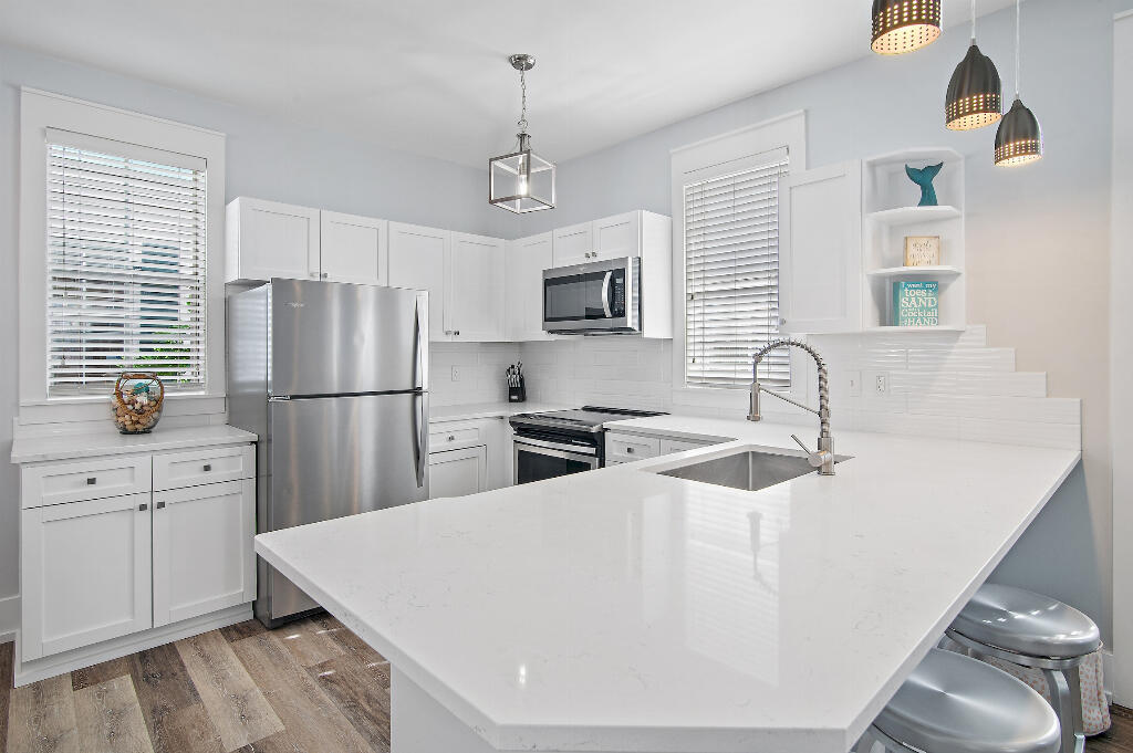 198 Somerset Bridge Road, Unit 123 Santa Rosa Beach, FL 32459 - Photo 7 of 21 a kitchen with stainless steel appliances a refrigerator sink and microwave