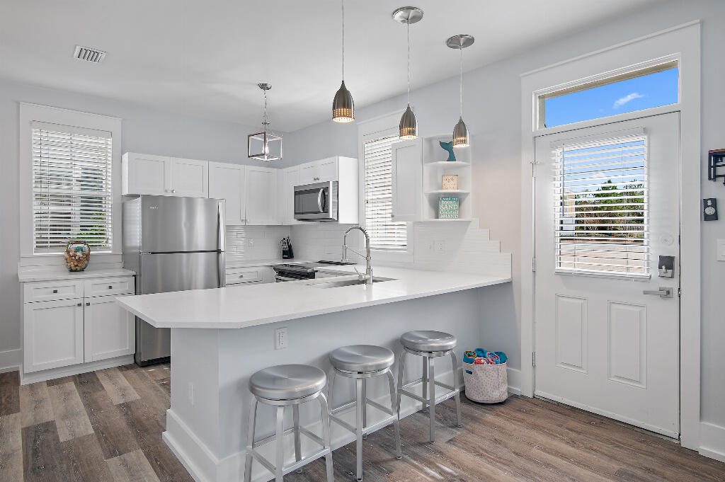 198 Somerset Bridge Road, Unit 123 Santa Rosa Beach, FL 32459 - Photo 8 of 21 a kitchen with stainless steel appliances granite countertop a refrigerator and a stove top oven