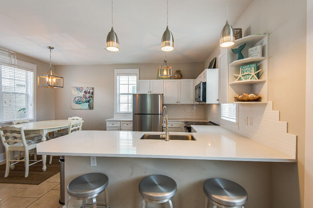198 Somerset Bridge Road, Unit 123 Santa Rosa Beach, FL 32459 - Photo 10 of 21 a kitchen with a table and chairs in it