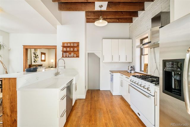 a kitchen with a sink stove and refrigerator