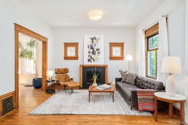 a living room with furniture fireplace and window