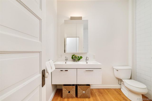 a bathroom with a sink toilet and mirror