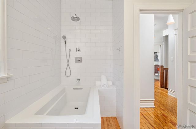 a bathroom with a tub and shower