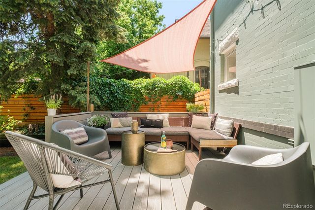 a view of a patio with couches chairs and a potted plant