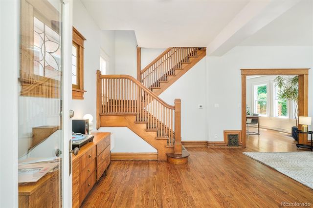 a view of an entryway with wooden floor and staircase