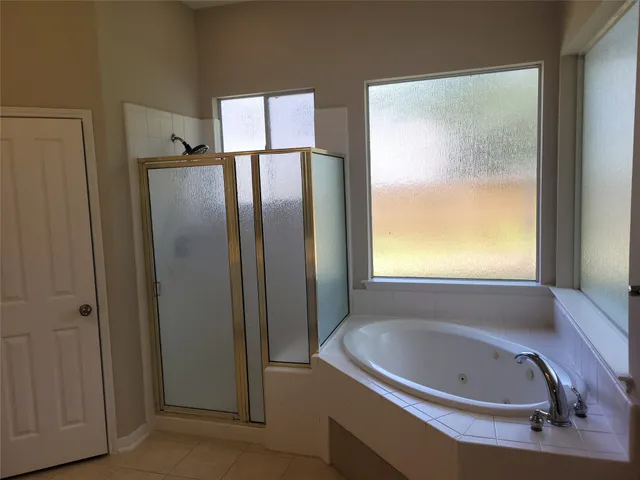 a bathroom with a bathtub and a window