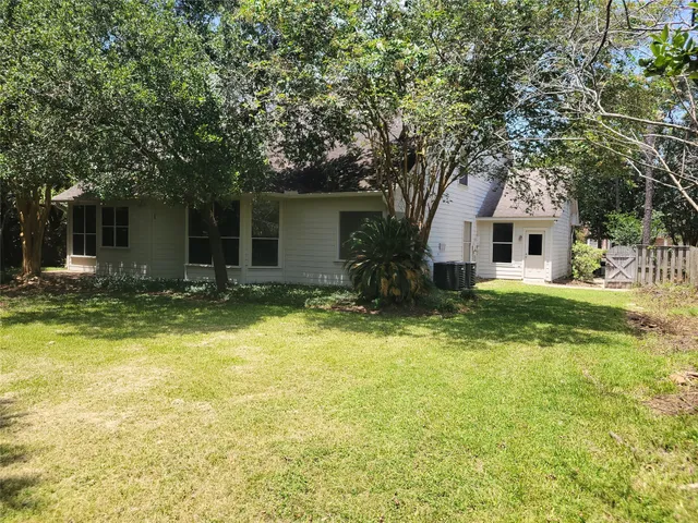 a front view of house with yard and trees around