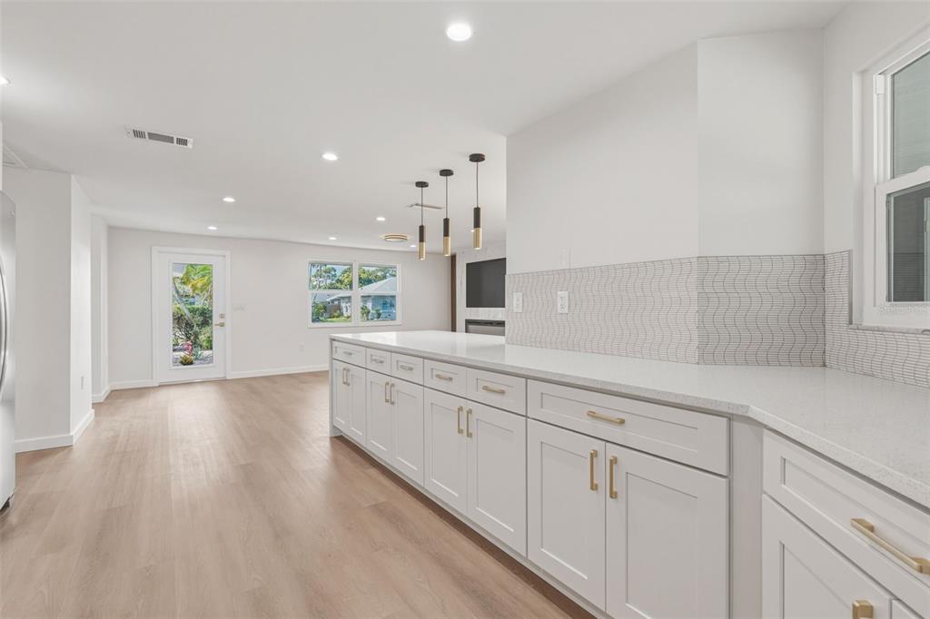 1330 Horizon Road Venice, FL 34293 - Photo 12 of 40 a large kitchen with cabinets wooden floor and a window